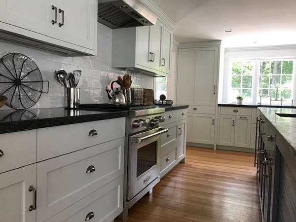 16 Pinecroft Road Weston, MA 02493 - Photo 3 of 18 a kitchen with stainless steel appliances granite countertop a sink a stove and cabinets