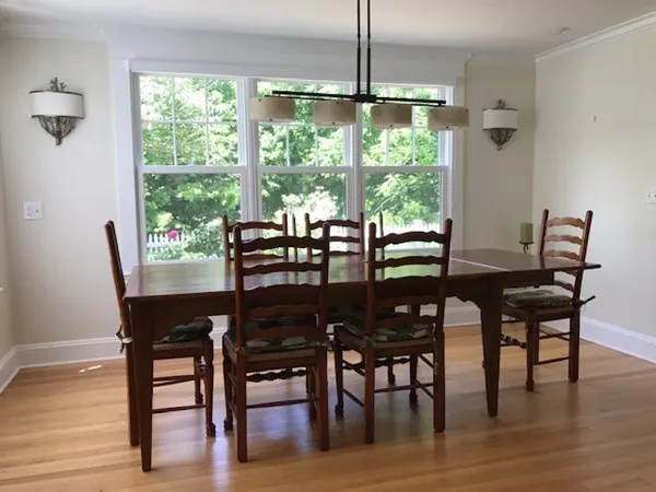 a view of a dining room with furniture window and wooden floor
