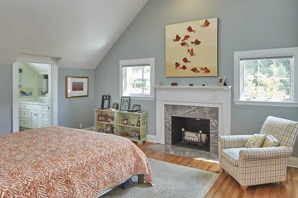 a bedroom with a bed and a fireplace