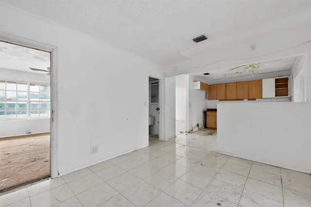 an empty room with closet and a chandelier fan