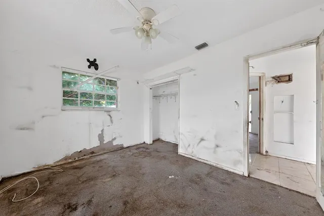 an empty room with sliding glass door and shower