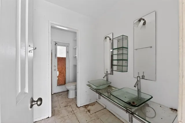 a view of storage and utility room with racks on the wall