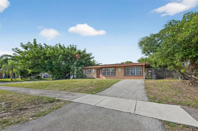a view of backyard of house with green space