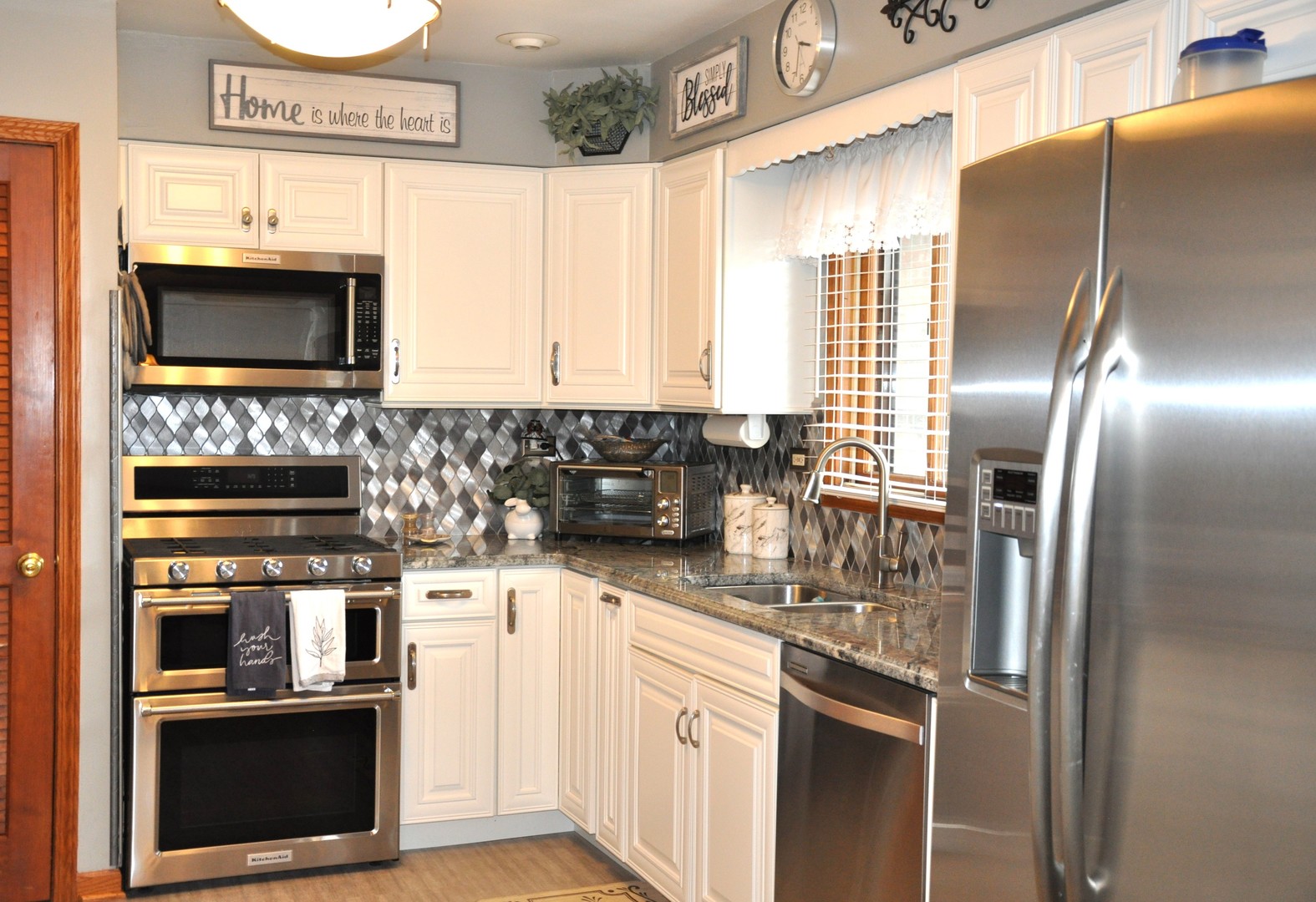 727 Sable Avenue Addison, IL 60101 - Photo 3 of 6 a kitchen with stainless steel appliances granite countertop a refrigerator a stove a sink and a microwave