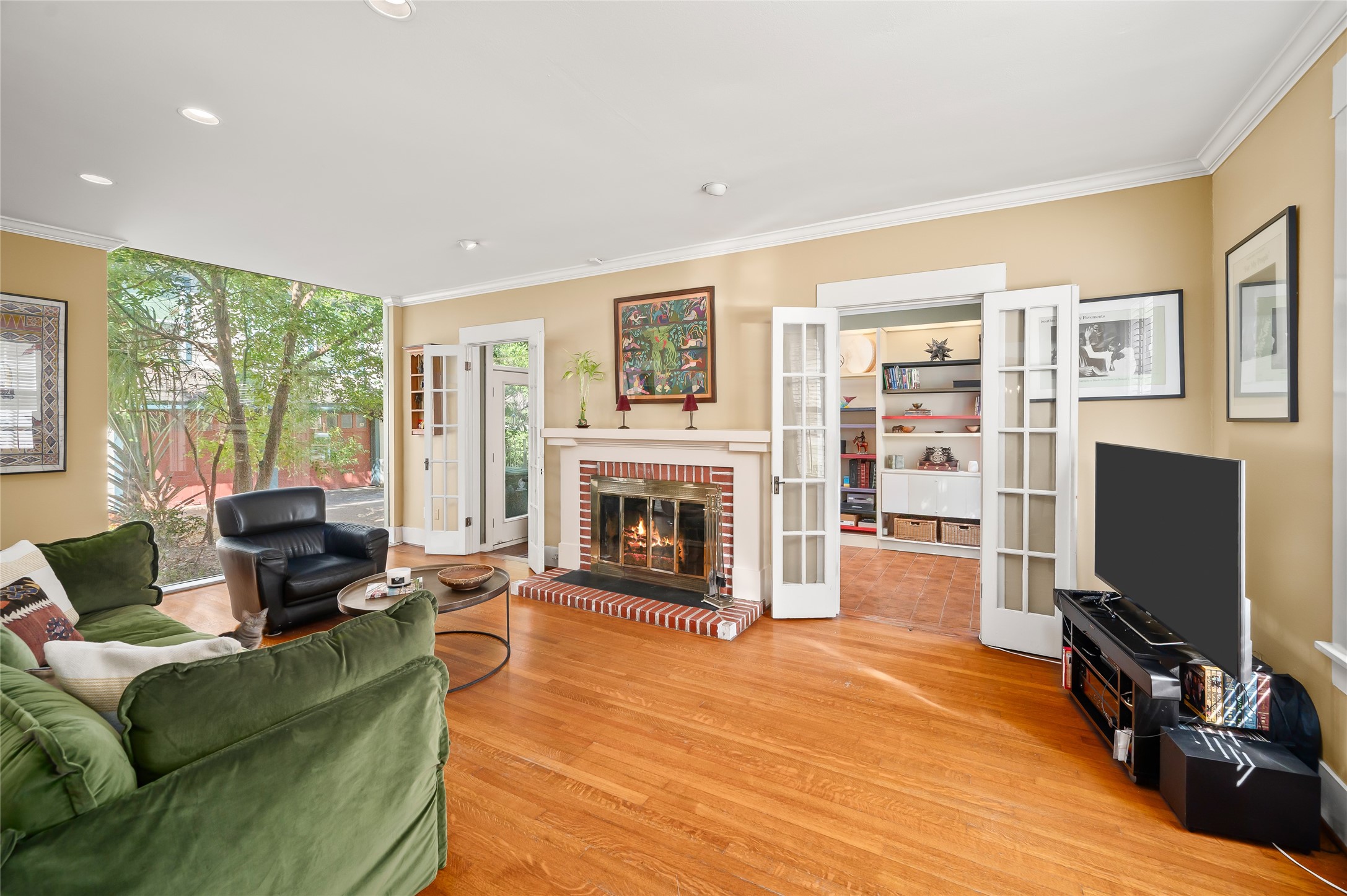 1534 Harold Street Houston, TX 77006 - Photo 2 of 41 a living room with furniture a flat screen tv and a fireplace