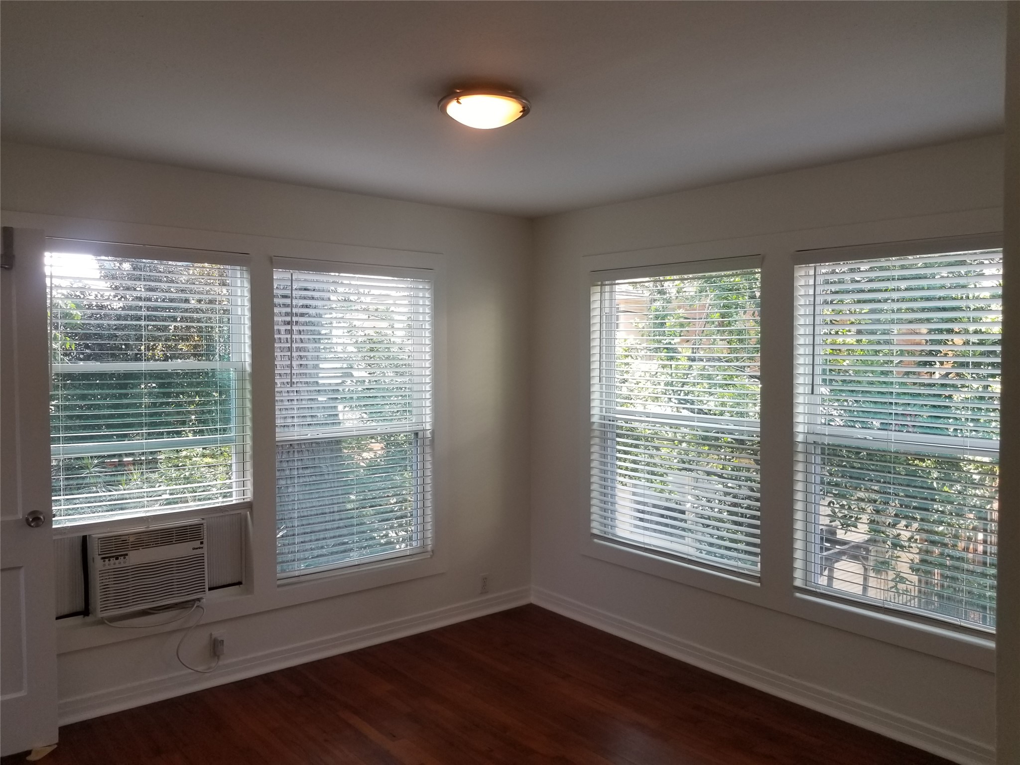1534 Harold Street Houston, TX 77006 - Photo 38 of 41 a view of an empty room with wooden floor and a window