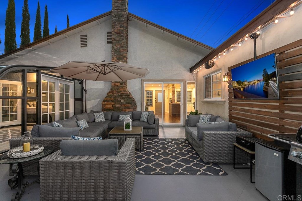 Welcome home!  This fantastic entertainers patio,  complete with speakers & flat screen included.