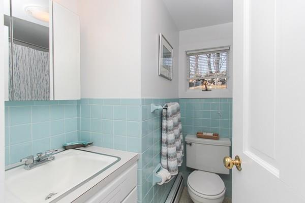 50 River Road Gloucester, MA 01930 - Photo 23 of 33 a bathroom with a sink a toilet and shower curtain