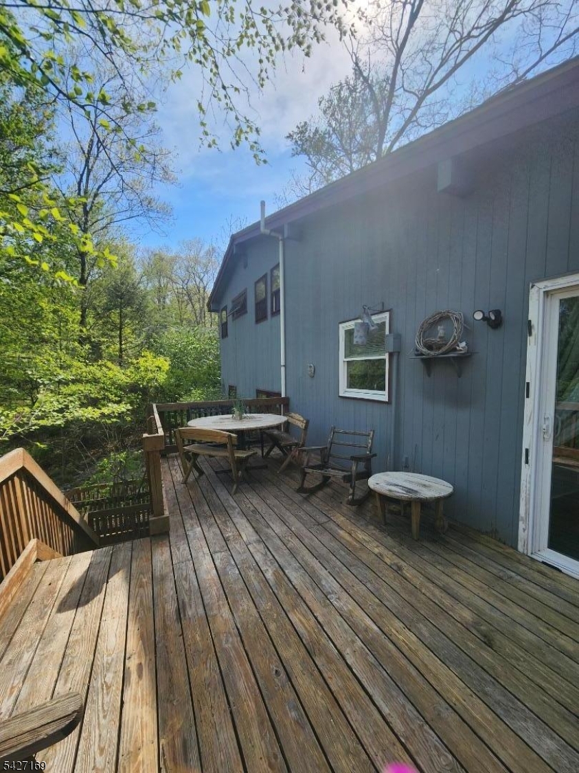 41 Crescent Drive South Andover, NJ 07821 - Photo 21 of 29 a balcony with wooden floor table and chairs