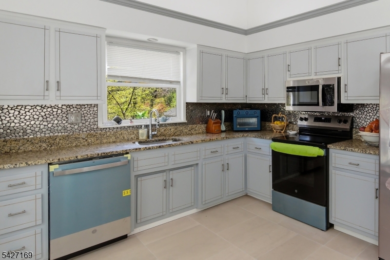 41 Crescent Drive South Andover, NJ 07821 - Photo 4 of 29 a kitchen with stainless steel appliances granite countertop a stove a sink and a microwave