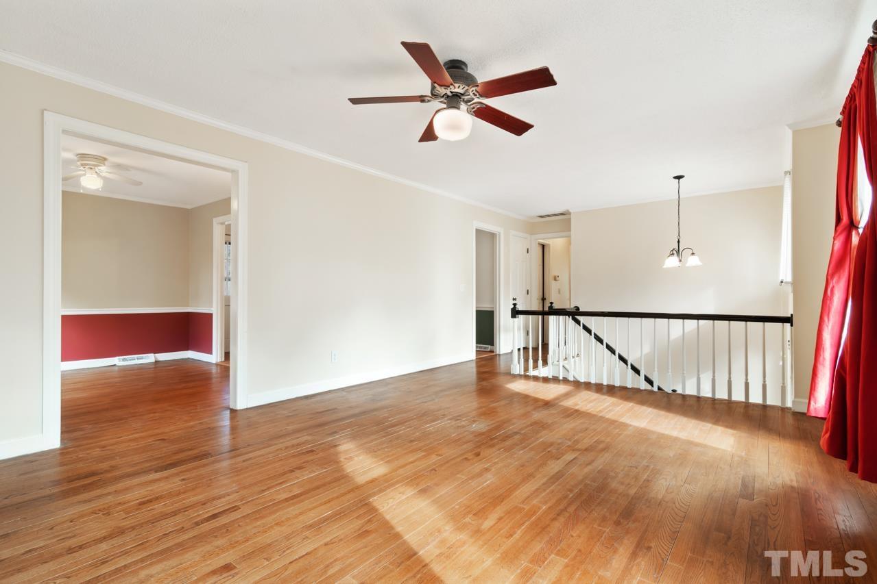 7028 Robbie Drive Raleigh, NC 27607 - Photo 3 of 15 a view of livingroom with hardwood floor and a ceiling fan