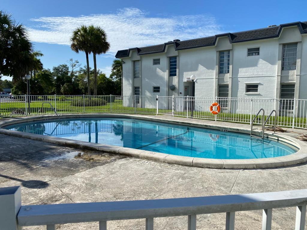 7232 Southwest 94th Place, Unit E7 Miami, FL 33173 - Photo 1 of 11 a view of swimming pool with a yard
