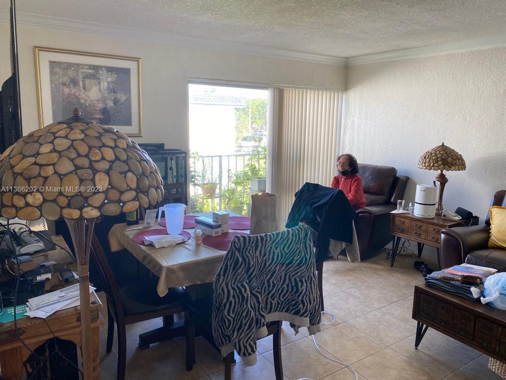 7232 Southwest 94th Place, Unit E7 Miami, FL 33173 - Photo 3 of 11 a living room with furniture and a window