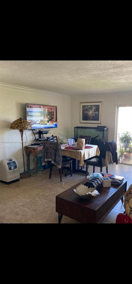 7232 Southwest 94th Place, Unit E7 Miami, FL 33173 - Photo 6 of 11 a living room with furniture and a flat screen tv