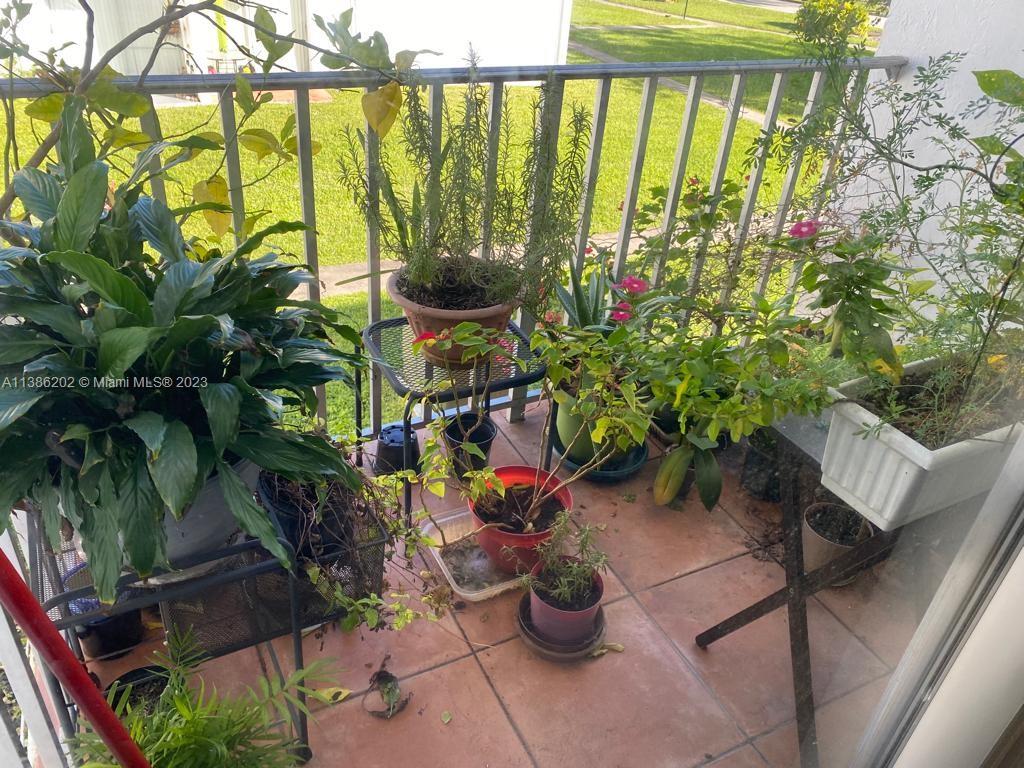 7232 Southwest 94th Place, Unit E7 Miami, FL 33173 - Photo 9 of 11 a view of a chairs and table in a patio