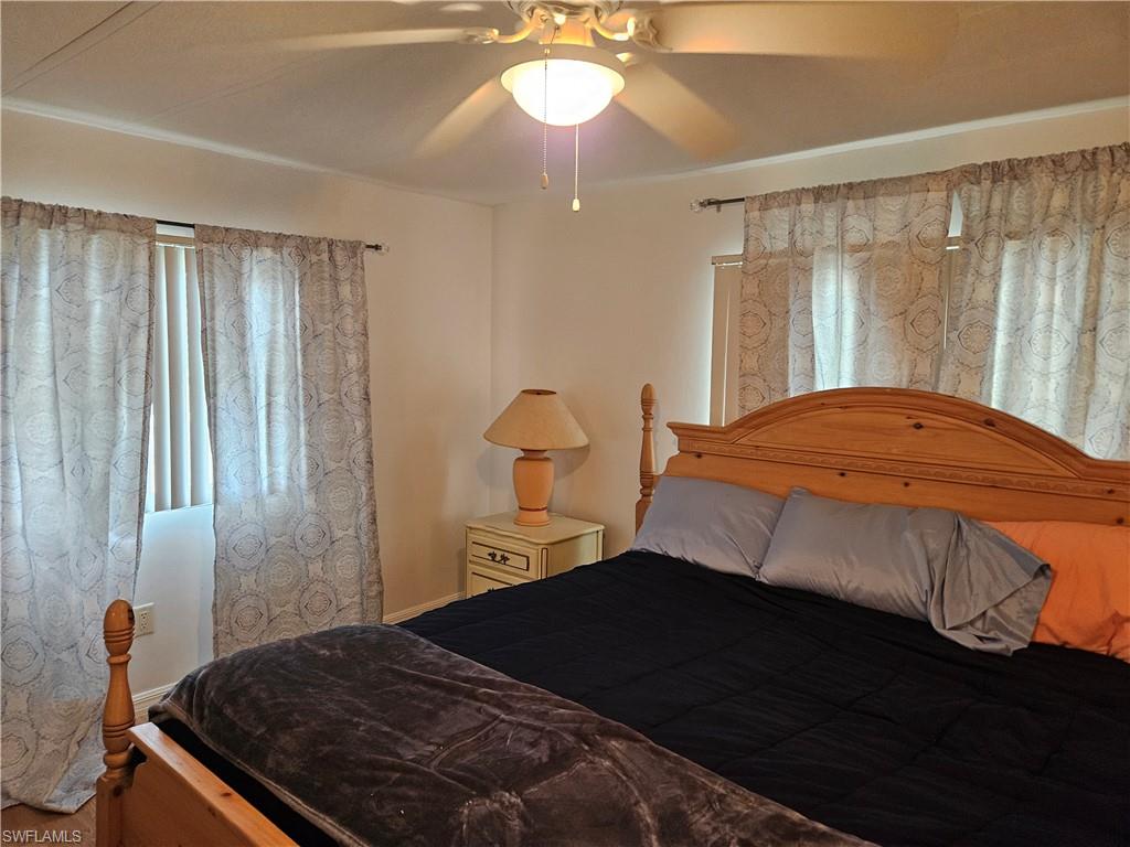 859 Manatee Road Naples, FL 34114 - Photo 7 of 37 Bedroom featuring ceiling fan and wood-type flooring