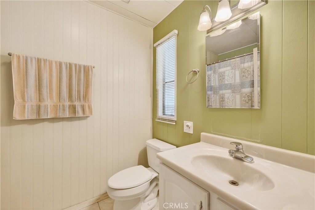 1001 West Lambert Road, Unit 258 La Habra, CA 90631 - Photo 25 of 75 a bathroom with a sink a toilet and mirror