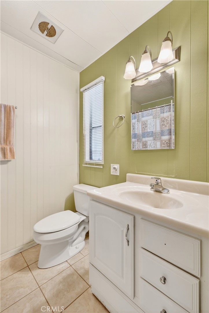 1001 West Lambert Road, Unit 258 La Habra, CA 90631 - Photo 26 of 75 a bathroom with a sink a toilet and mirror