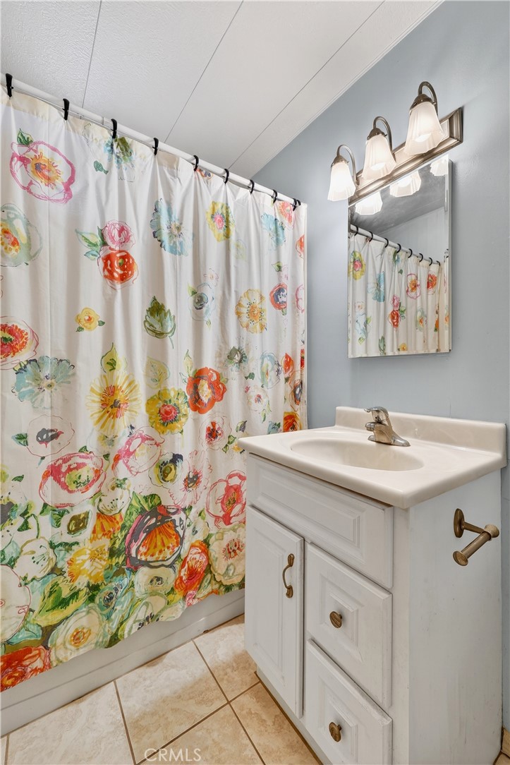 1001 West Lambert Road, Unit 258 La Habra, CA 90631 - Photo 30 of 75 a bathroom with a sink and a shower curtain