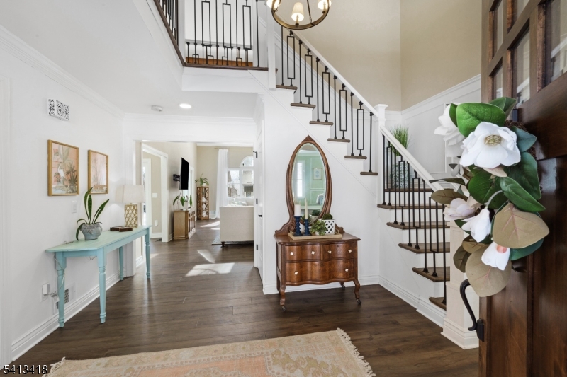 a view of entryway and hall with wooden floor