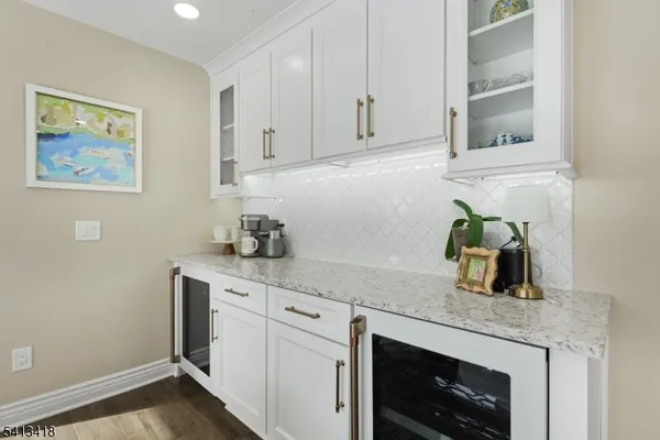 a kitchen with granite countertop white cabinets and white appliances