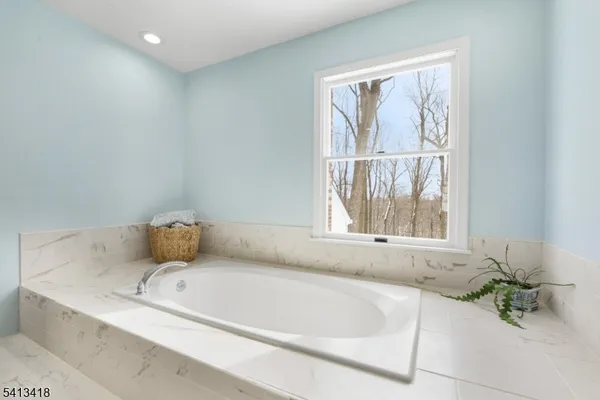 a bathroom with a tub and shower
