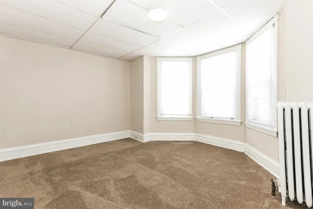 an empty room with a empty space and a window