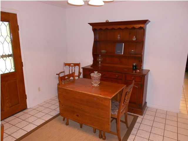 1874 Bay Grove Road Freeport, FL 32439 - Photo 3 of 10 a room with a table and a fireplace