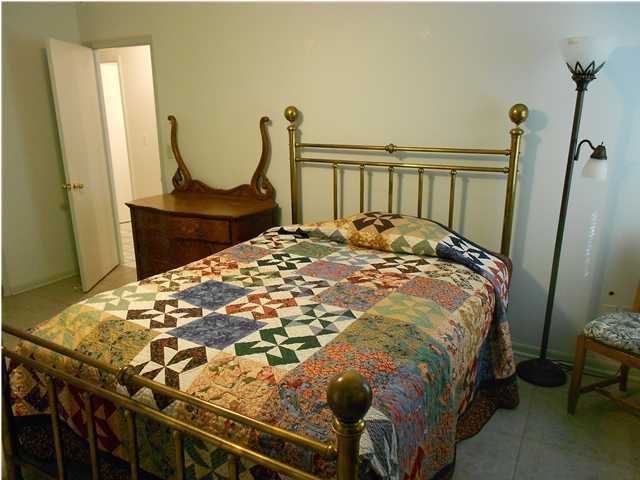 1874 Bay Grove Road Freeport, FL 32439 - Photo 8 of 10 a bed sitting in a bedroom next to a window