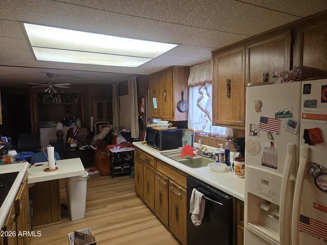 a kitchen with stainless steel appliances kitchen island granite countertop a sink stove and cabinets