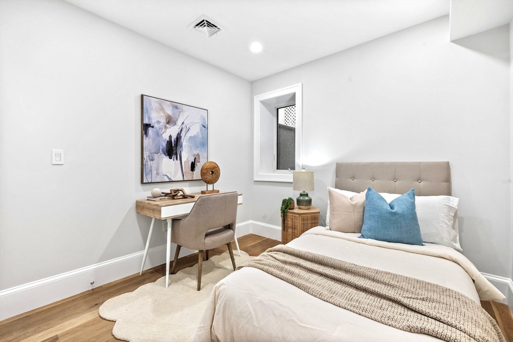12 Prospect Street, Unit 1 Boston, MA 02129 - Photo 13 of 20 a bedroom with a bed and a table in it