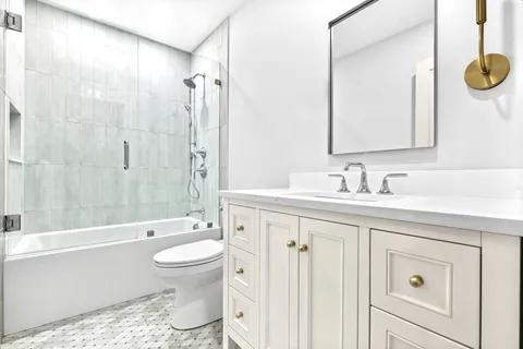 a bathroom with a sink a toilet and vanity