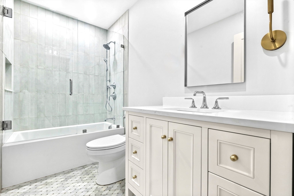 12 Prospect Street, Unit 1 Boston, MA 02129 - Photo 14 of 20 a bathroom with a sink a toilet and shower