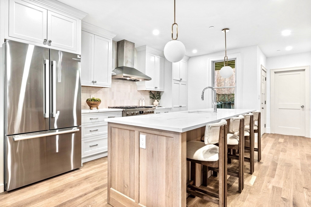 12 Prospect Street, Unit 1 Boston, MA 02129 - Photo 6 of 20 a kitchen with cabinets and stainless steel appliances