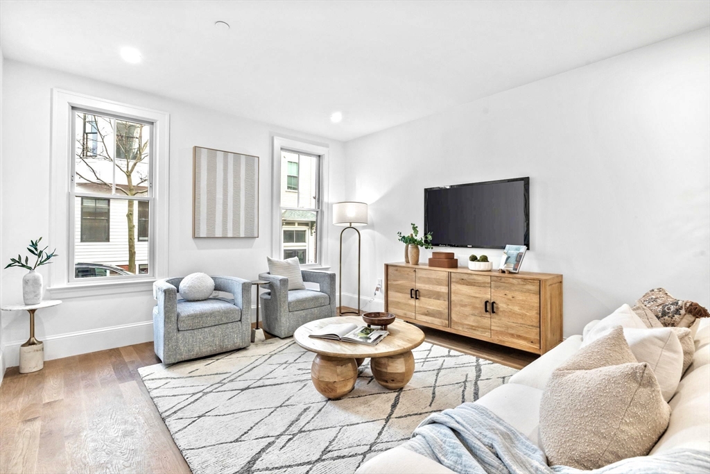 12 Prospect Street, Unit 1 Boston, MA 02129 - Photo 8 of 20 a living room with furniture and a flat screen tv