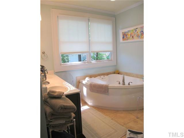 2208 Creston Road Raleigh, NC 27608 - Photo 13 of 23 a bathroom with a bathtub and a window