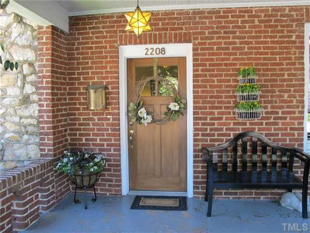 2208 Creston Road Raleigh, NC 27608 - Photo 20 of 23 a front view of a house with a potted plant
