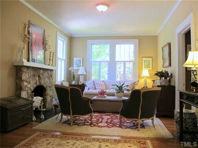 2208 Creston Road Raleigh, NC 27608 - Photo 3 of 23 a living room with furniture a rug and a fireplace