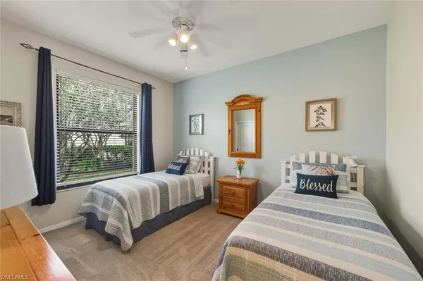 a spacious bedroom with a bed and a large window