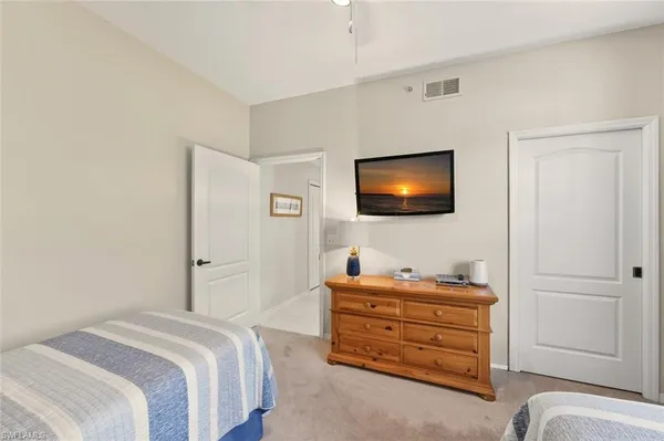 a bedroom with a bed and television