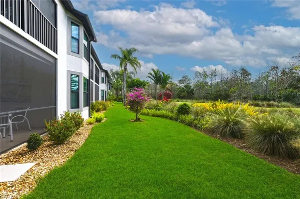 a view of a house with a yard and a garden