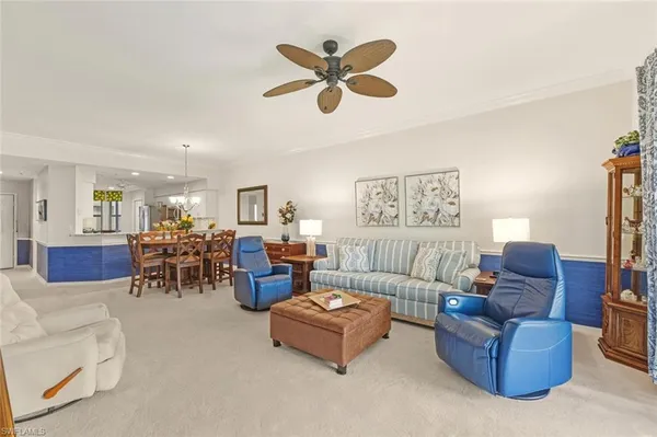 a living room with furniture and kitchen view