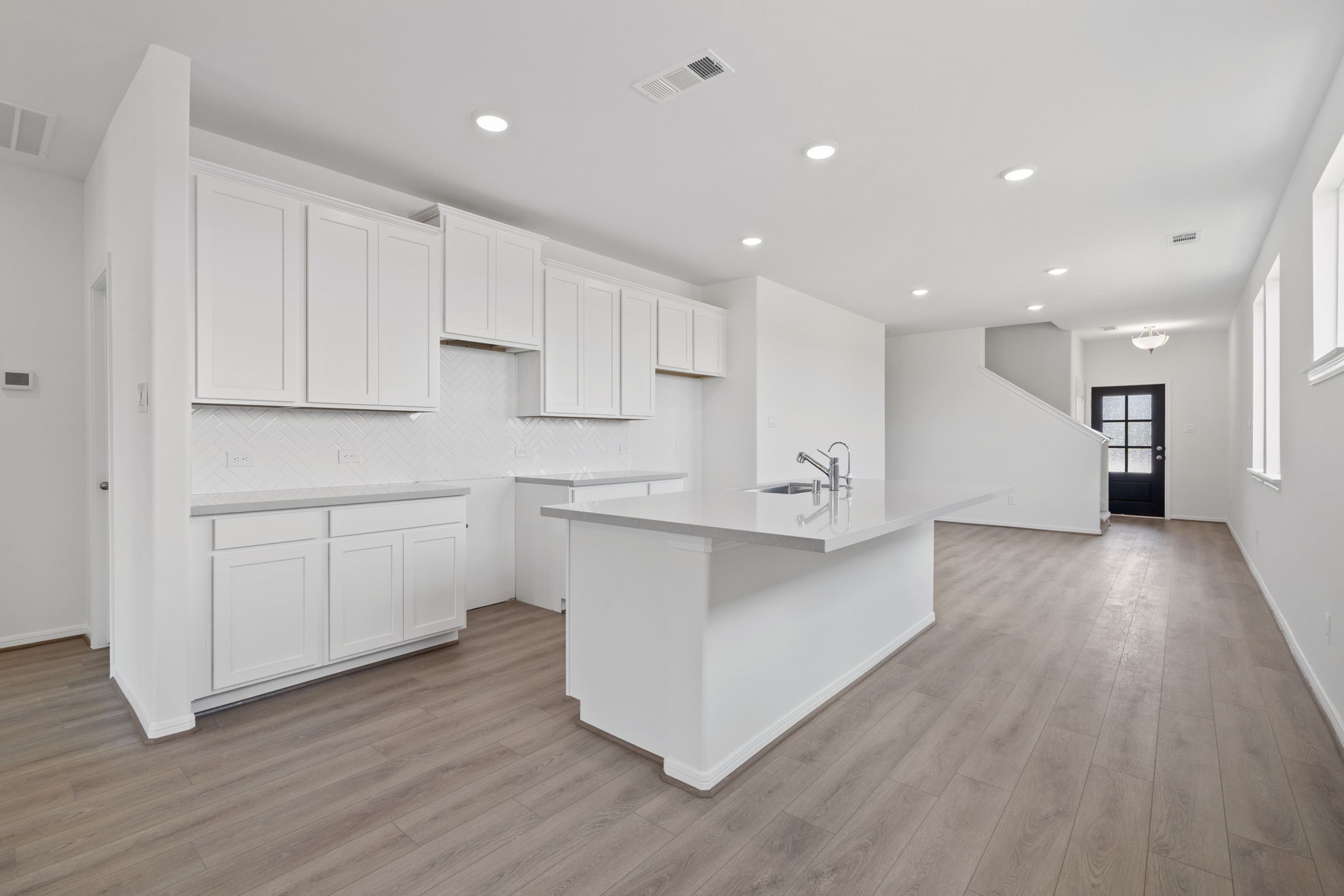23619 Cinnamon Tree Lane Katy, TX 77493 - Photo 10 of 33 a kitchen with a white wooden cabinets and window