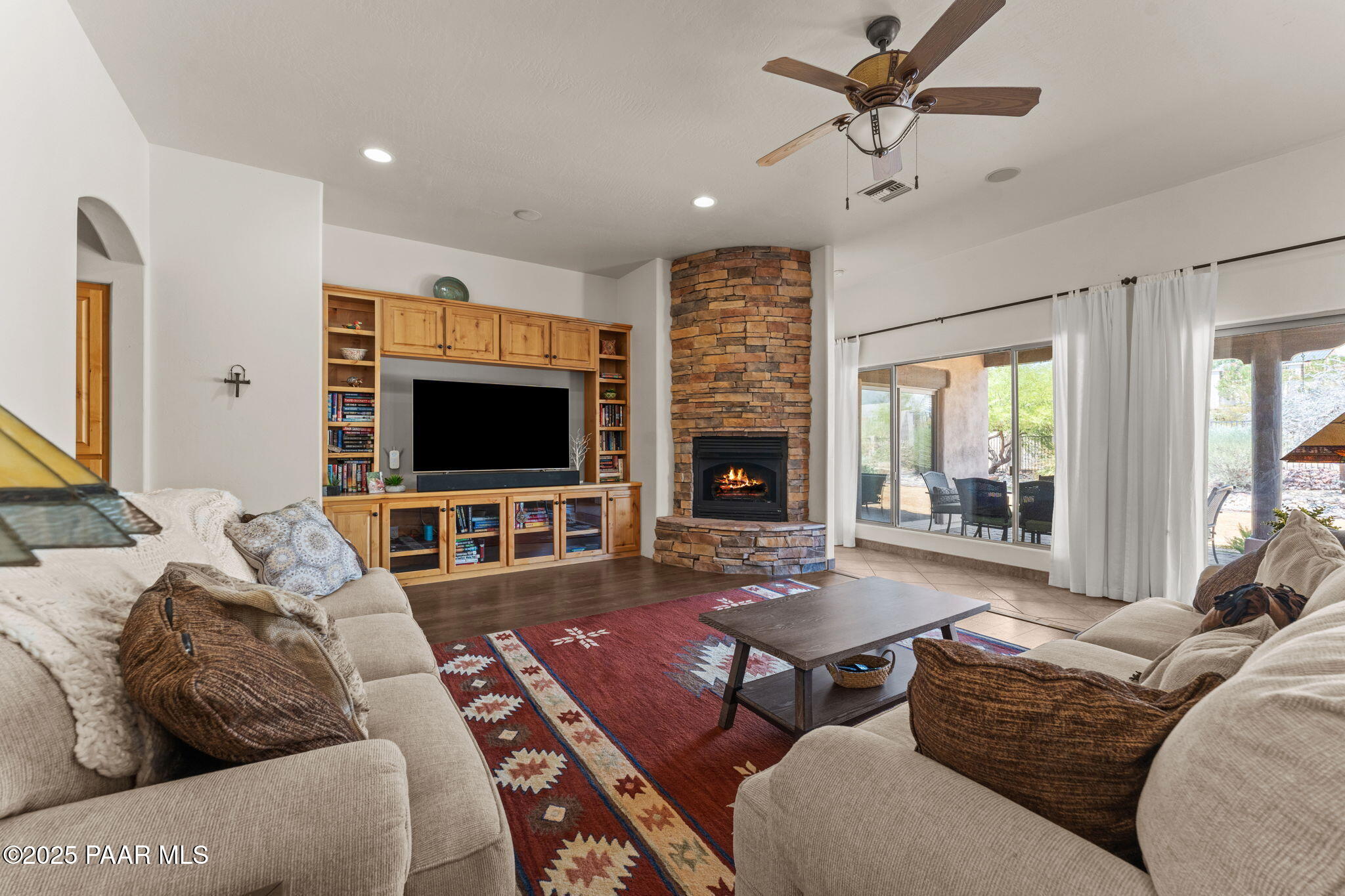 2100 West Silverlode Drive Wickenburg, AZ 85390 - Photo 2 of 51 a living room with furniture flat screen tv and a fireplace