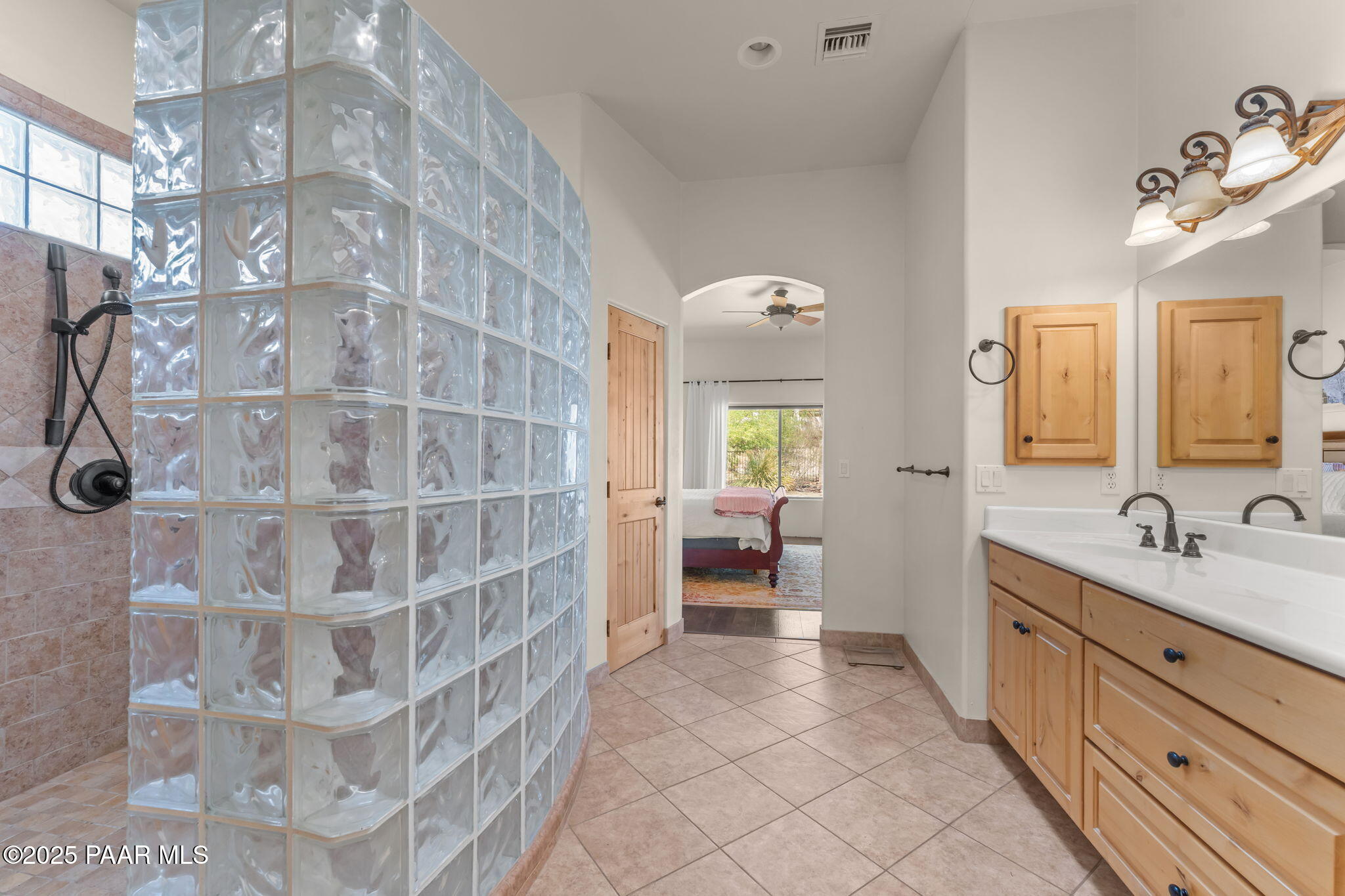2100 West Silverlode Drive Wickenburg, AZ 85390 - Photo 25 of 51 a spacious bathroom with a double vanity sink a mirror and a bathtub