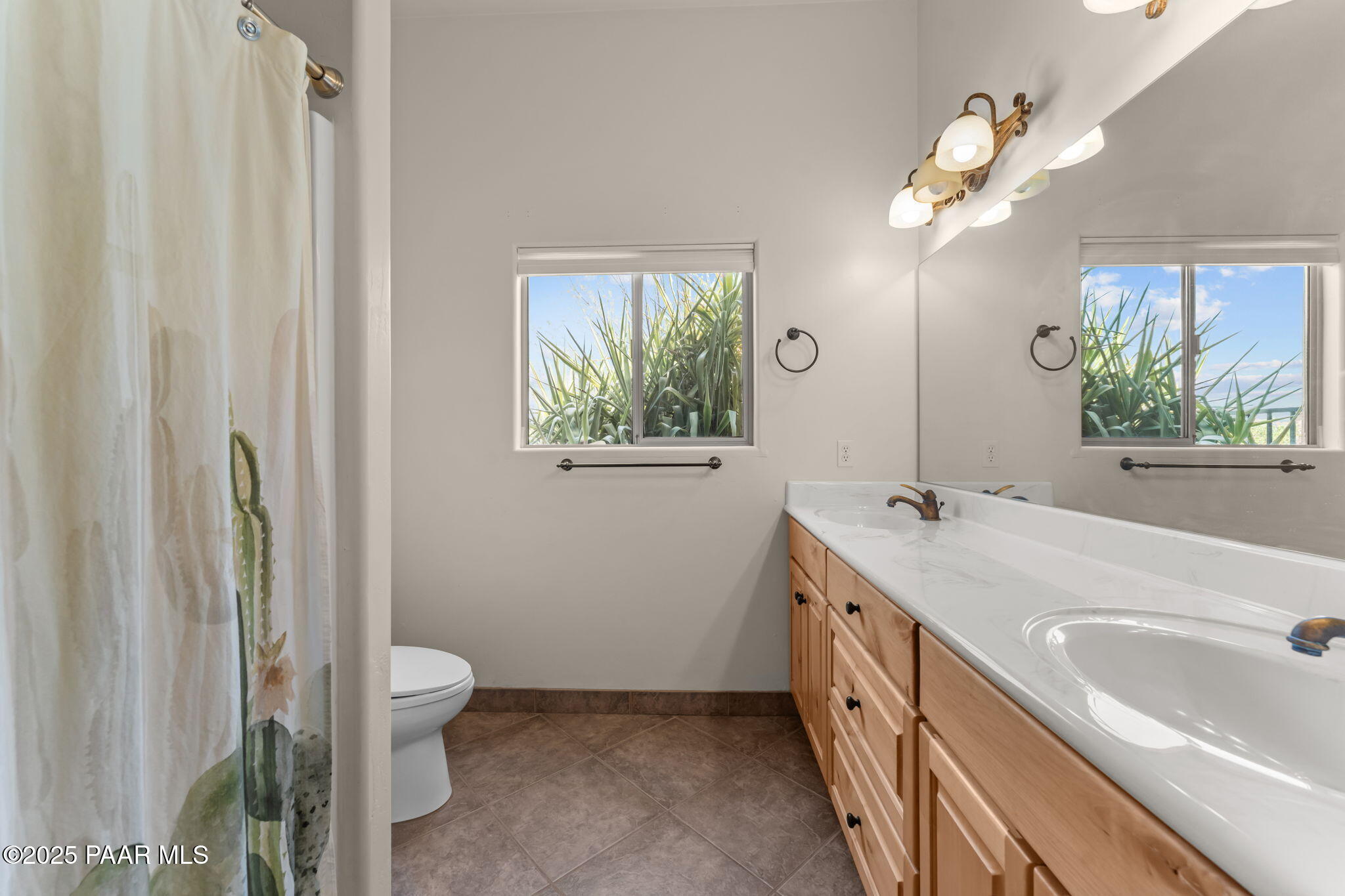 2100 West Silverlode Drive Wickenburg, AZ 85390 - Photo 31 of 51 a bathroom with a double vanity sink a toilet a mirror a vanity and window