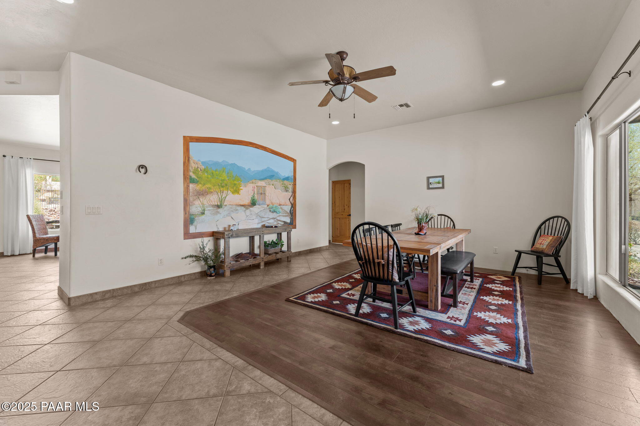2100 West Silverlode Drive Wickenburg, AZ 85390 - Photo 6 of 51 a living room with furniture a window and a chandelier