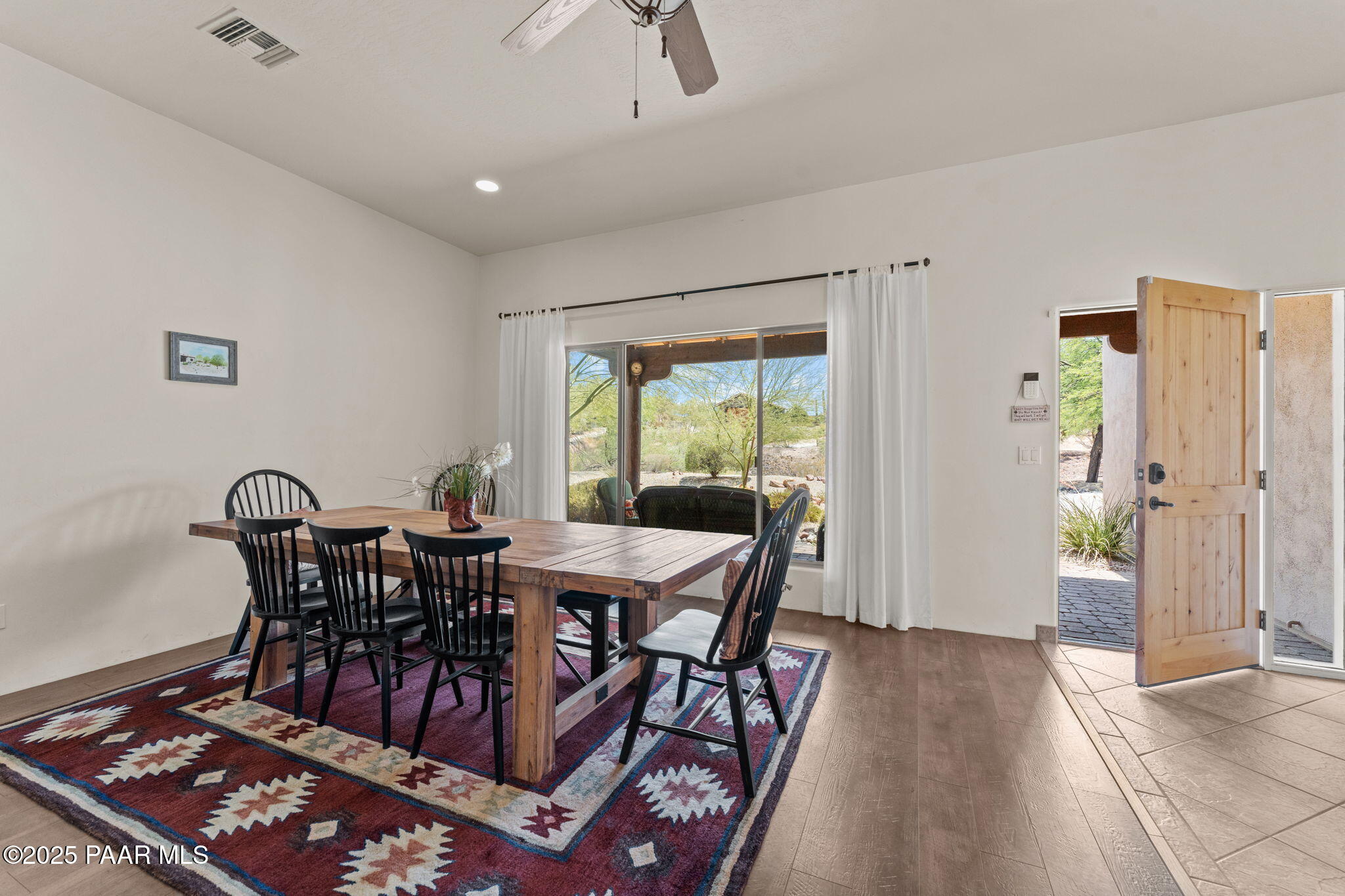 2100 West Silverlode Drive Wickenburg, AZ 85390 - Photo 7 of 51 a view of a dining room with furniture and wooden floor