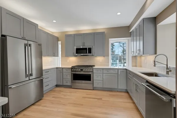 a kitchen with a refrigerator stove and sink