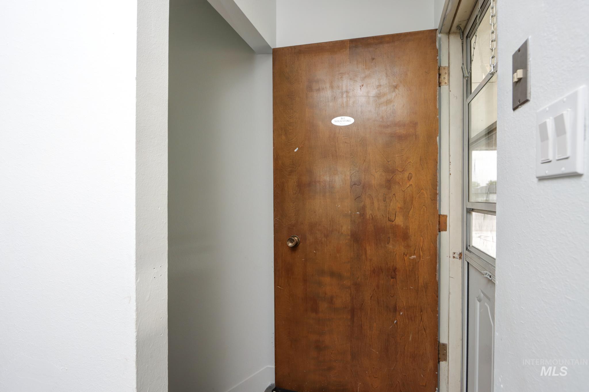 801 Thompson Avenue Nyssa, OR 97913 - Photo 14 of 46 Wood-finish entry door with brass-tone hardware